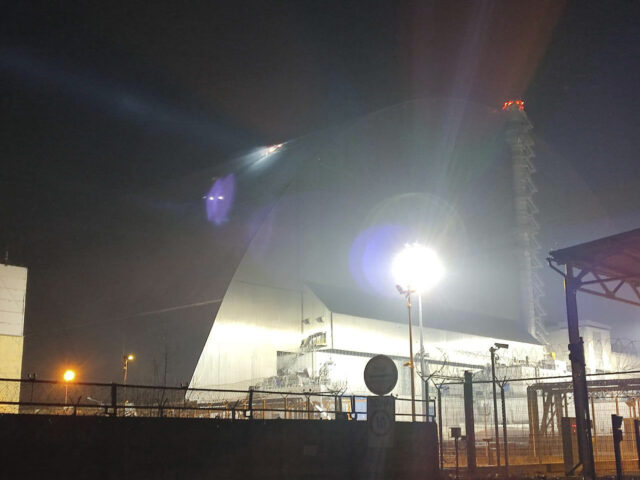 In this photo provided by the Ukrainian Emergency Service, a searchlight illuminates a hol