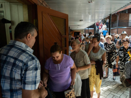 People can be seen lining up for humanitarian aid after attending a Sunday service in a Ca