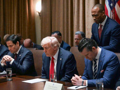 President Donald Trump prays as he holds his first Cabinet meeting at the White House in W