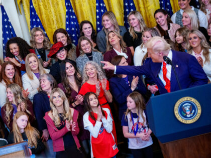 Sage Steele (L) reacts while standing behind U.S. President Donald Trump as he recognizes