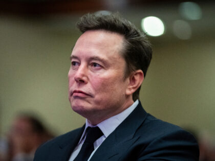 Elon Musk listens as President-elect Donald Trump speaks during a meeting with the House G