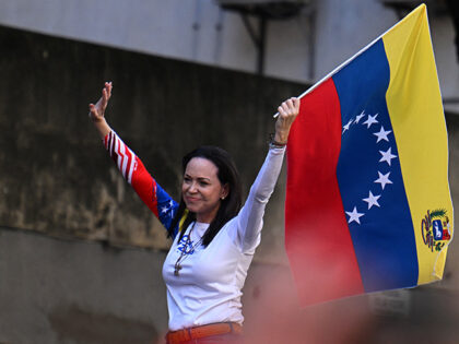 Venezuelan opposition leader Maria Corina Machado waves a national flag during a protest c