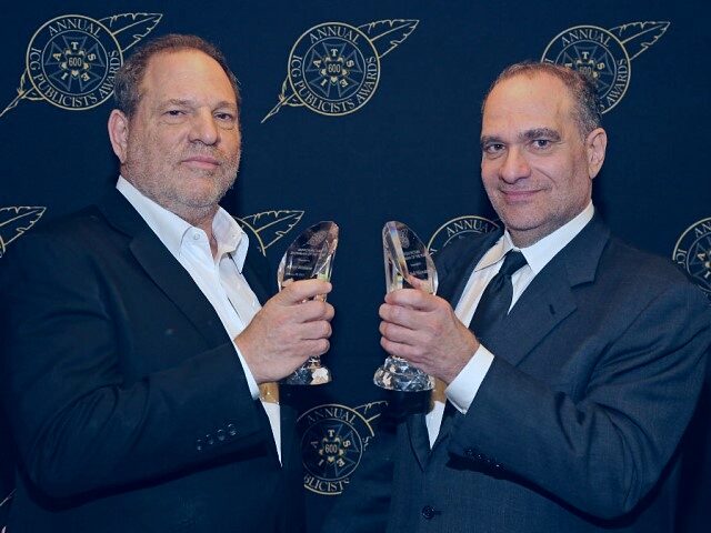 Harvey Weinstein (L) and Bob Weinstein pose with the Motion Picture Showmanship Award back