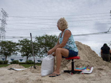 A woman fill sandbags at Joe DiMaggio Sports Complex for possible flooding ahead of the ar