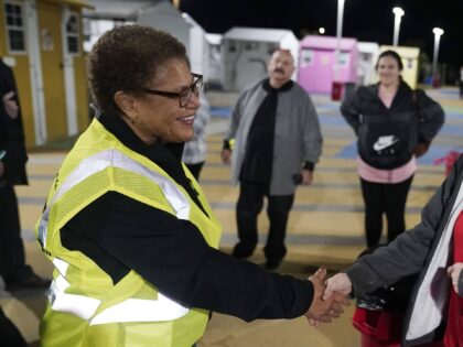 Mayor Karen Bass, left, shakes hands with /Faith Pennington, a homeless woman living in a