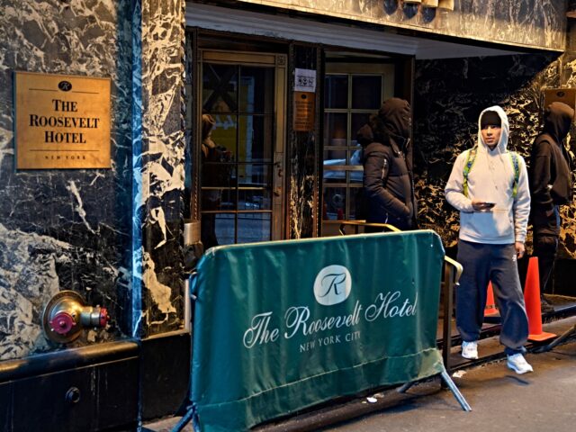 People come out of the Roosevelt Hotel migrant center on February 24, 2025 in New York Cit