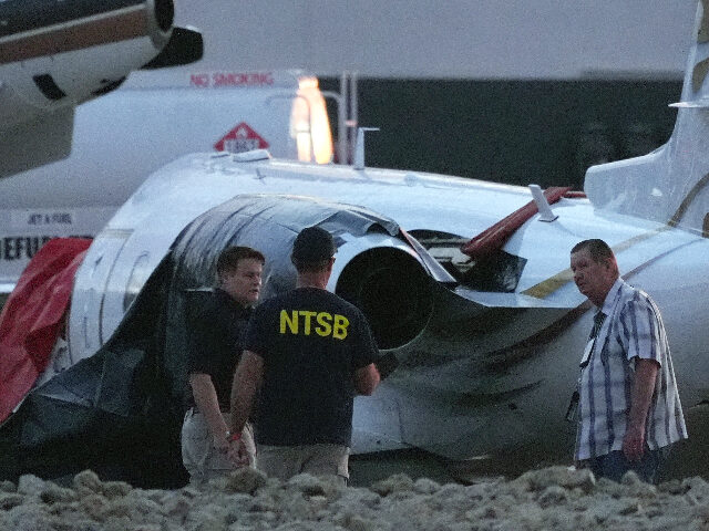 Scottdaleplanecrash Investigators look at a crashed Learjet at Scottsdale Airport after it collided with a par