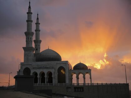 A Palestinian man walks into the beach mosque to attend the noon prayer during cloudy and