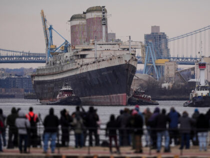 The SS United States is towed down the Delaware River between Pennsylvania and New Jersey,