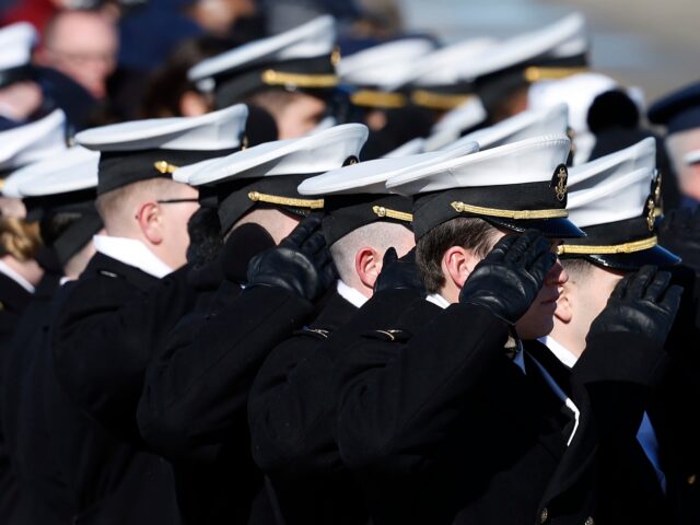 JOINT BASE ANDREWS, MARYLAND - JANUARY 09: U.S. Naval Academy Midshipmen salute as the fla