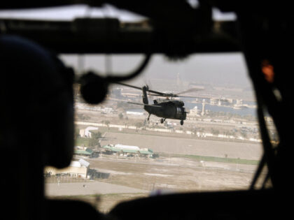 A US army Blackhawk helicopter flies over former Iraqi president Saddam Hussein's al-