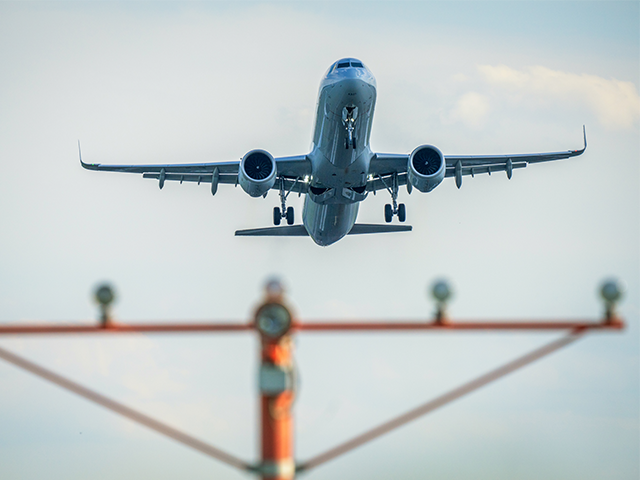 airplane-jet-2024-getty ARLINGTON, VA - AUGUST 12: A passenger jet takes off over the runway threshold lights at R