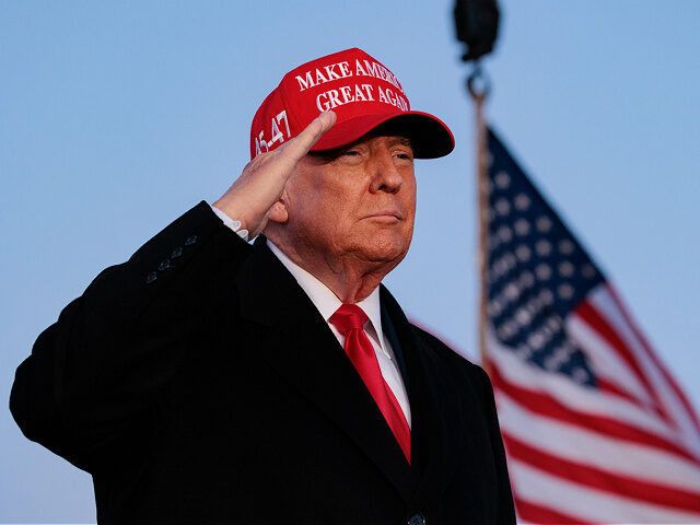 Former US President Donald Trump salutes during a campaign rally at the Schnecksville Fire