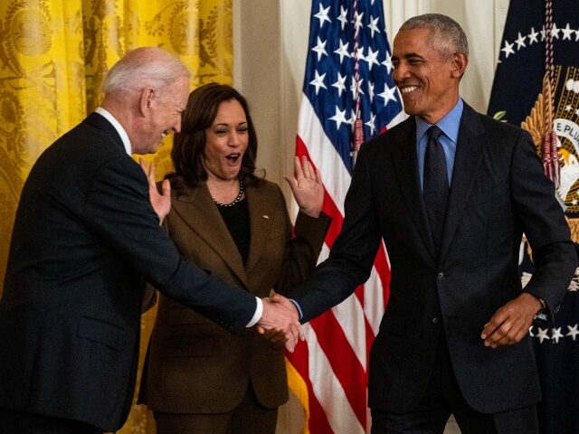 WASHINGTON, CA - APRIL 05: President Joe Biden shakes hands with former President Barack O