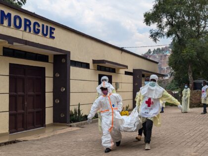 Members of the Congolese Red Cross carry body bags containing the remains of victims of th