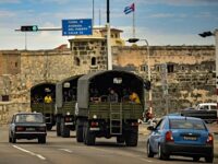 TOPSHOT - Police vehicles drive along El Paseo del Prado street in Havana, on November 15,