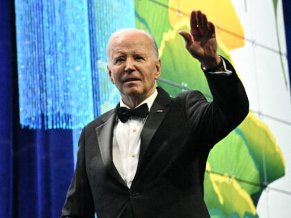 US President Joe Biden waves onstage at the Asian Pacific American Institute for Congressi