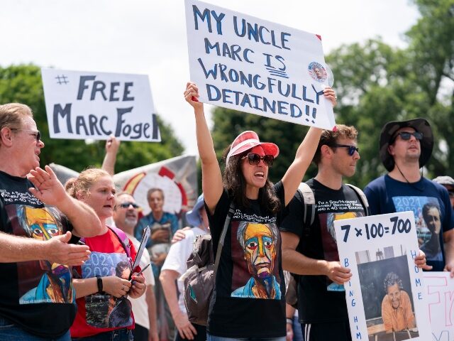 FILE - Ellen Keelan, center, and other family members rally outside the White House for th