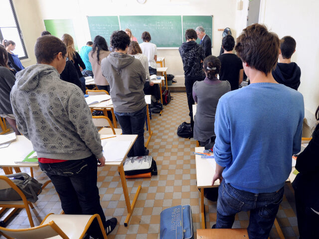 Students and their teacher observe a minute of silence, on March 20, 2012 at the Perier pu