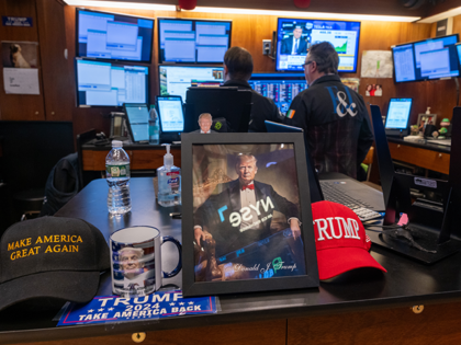 A picture of Donald Trump is displayed as traders work on the New York Stock Exchange (NYS