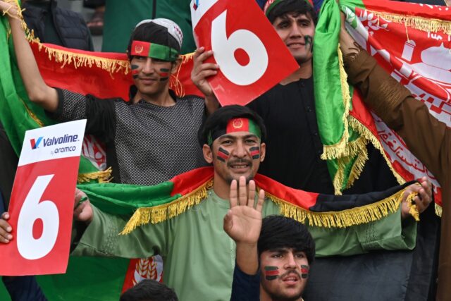 Afghans painted in red green and black cheer from Lahore and Kabul as their team seeks Cha