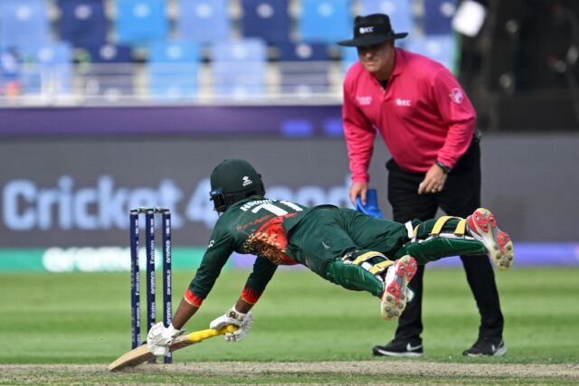 Bangladesh's century-maker Towhid Hridoy dives to reach the crease