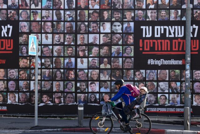 A billboard in Jerusalem shows people taken as hostages in Hamas's October 7, 2023 attack