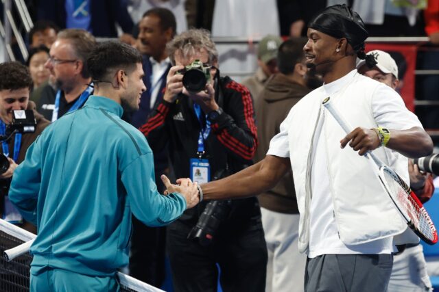 Carlos Alcaraz (left) shakes hands with Jimmy Butler as they put on a bonus show for fans