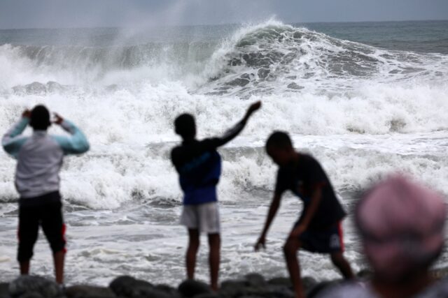 Children playing on the beach in Saint-Denis the day before Cyclone Garance was due to hit