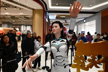 A dancing humanoid robot gyrates to music at a fair in Beijing during China's week-long Lu