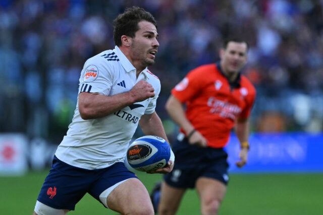 On the run: France captain Antoine Dupont goes in to score one of his side's 11 tries in a