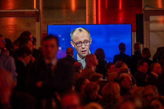 Friedrich Merz is seen on a screen during the TV debate in Berlin ahead of elections on Fe