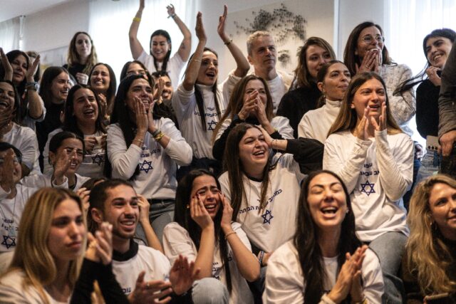 Friends and family of Israeli hostage Omer Shem Tov celebrate as they watch his televised