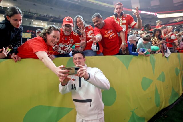 Kansas City Chiefs punter Matt Araiza takes a selfie with Chiefs fans inside the Superdome