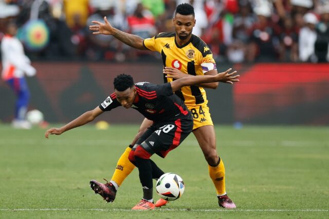 Orlando Pirates forward Relebohile Mofokeng (L) shields the ball from Kaizer Chiefs defend