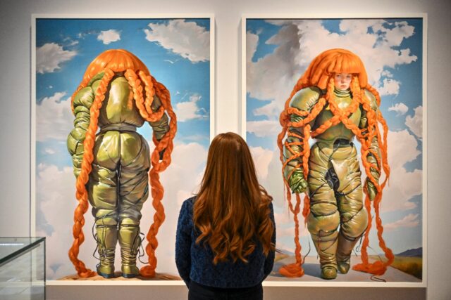 A person looks at AI artwork created by Holly Herndon and Mat Dryhurst called‘Embedding
