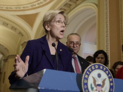 Sen. Elizabeth Warren, D-Mass., joined at right by Senate Minority Leader Chuck Schumer, D