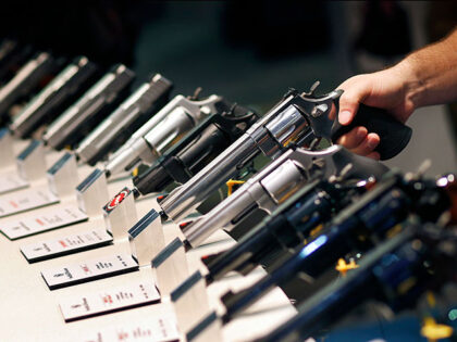 In this Jan. 19, 2016 file photo, handguns are displayed at the Shooting, Hunting and Outd