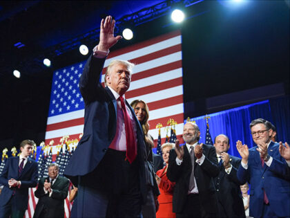 Republican presidential nominee former President Donald Trump waves as he walks with forme