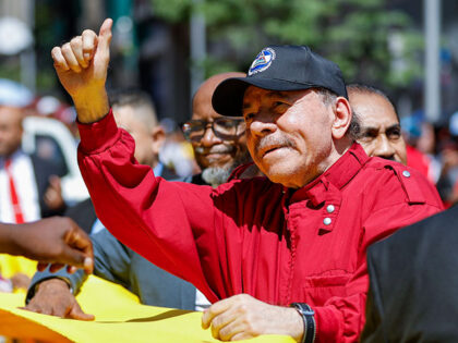 Nicaragua's President Daniel Ortega gestures to government supporters after attending the