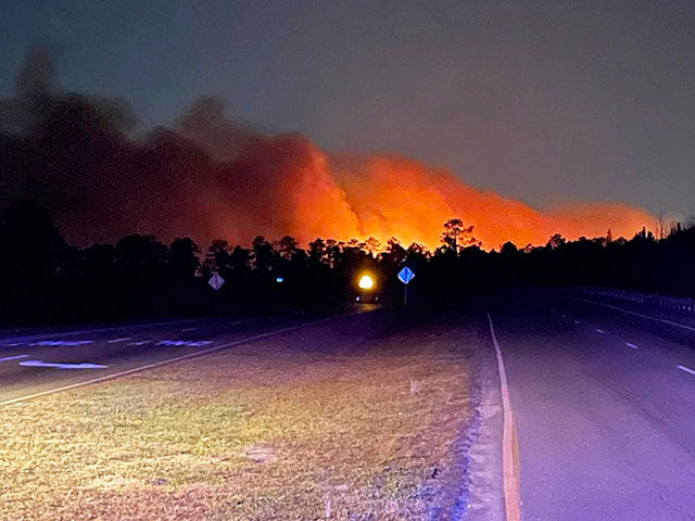 In this photo released by the Horry County Fire Rescue, smoke is seen from fires in Horry