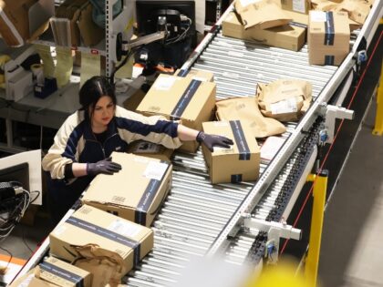 Amazon warehouse worker processes packages