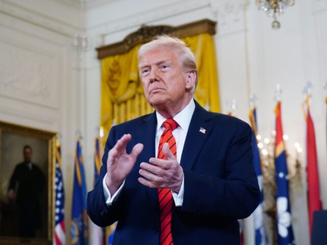 US President Donald Trump claps after signing an executive order in the East Room of the W