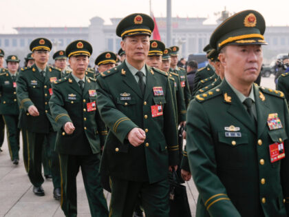 Military delegates march ahead of the opening session of the National People's Congre