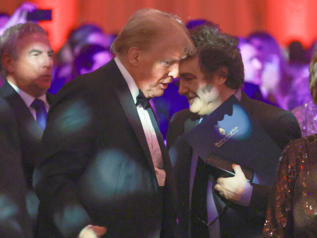 Donald Trump and Javier Milei Argentine President Javier Milei walks past U.S. President-elect Donald Trump as they atte