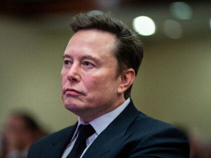 Elon Musk listens as President-elect Donald Trump speaks during a meeting with the House G