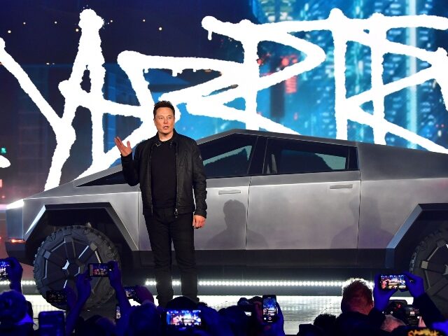 Elon Musk standing in front of Cybertruck