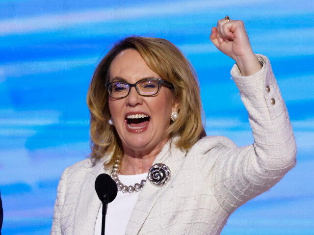 Gun control advocate and former U.S. Rep. Gabby Giffords (D-AZ) arrive to speak on stage d