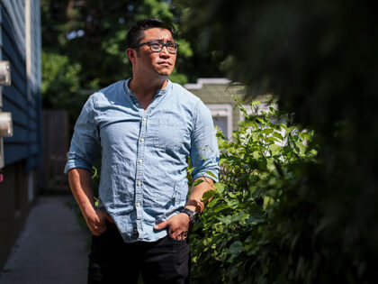 Roger Lau, deputy executive director of the DNC, poses for a portrait in the backyard of h