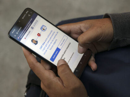 A migrant uses the CBP One application during an Al Otro Lado training session in Tijuana,